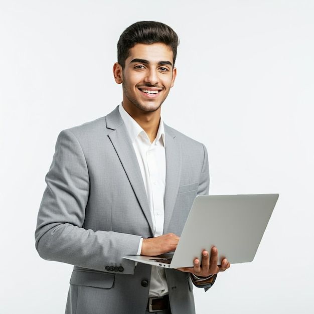 A man in a grey suit is holding a laptop _ Premium AI-generated image